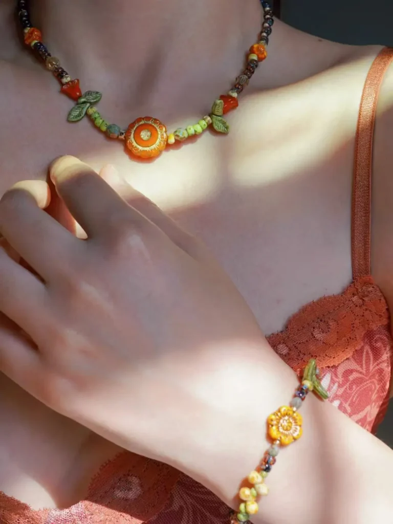 Woman wearing handmade Czech glass bead necklace and bracelet in natural light