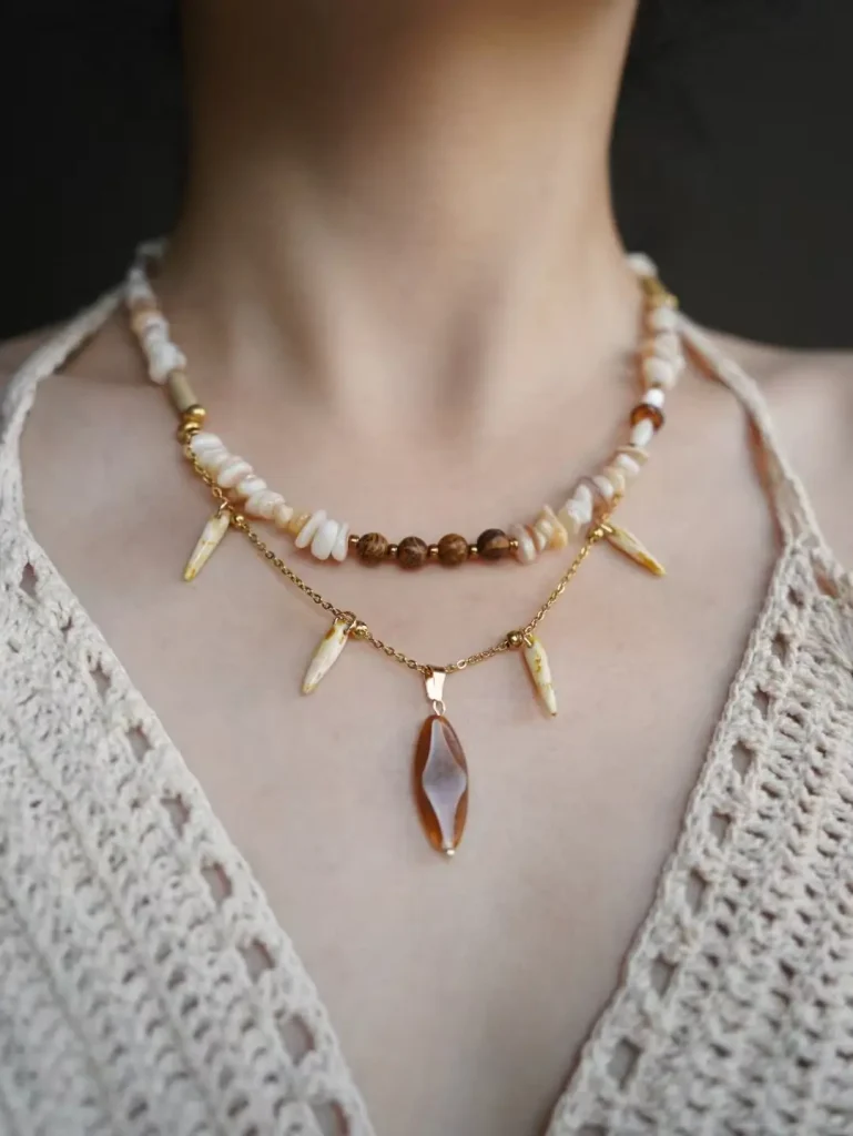 Customer wearing handmade necklace with vintage hill-inspired beaded design