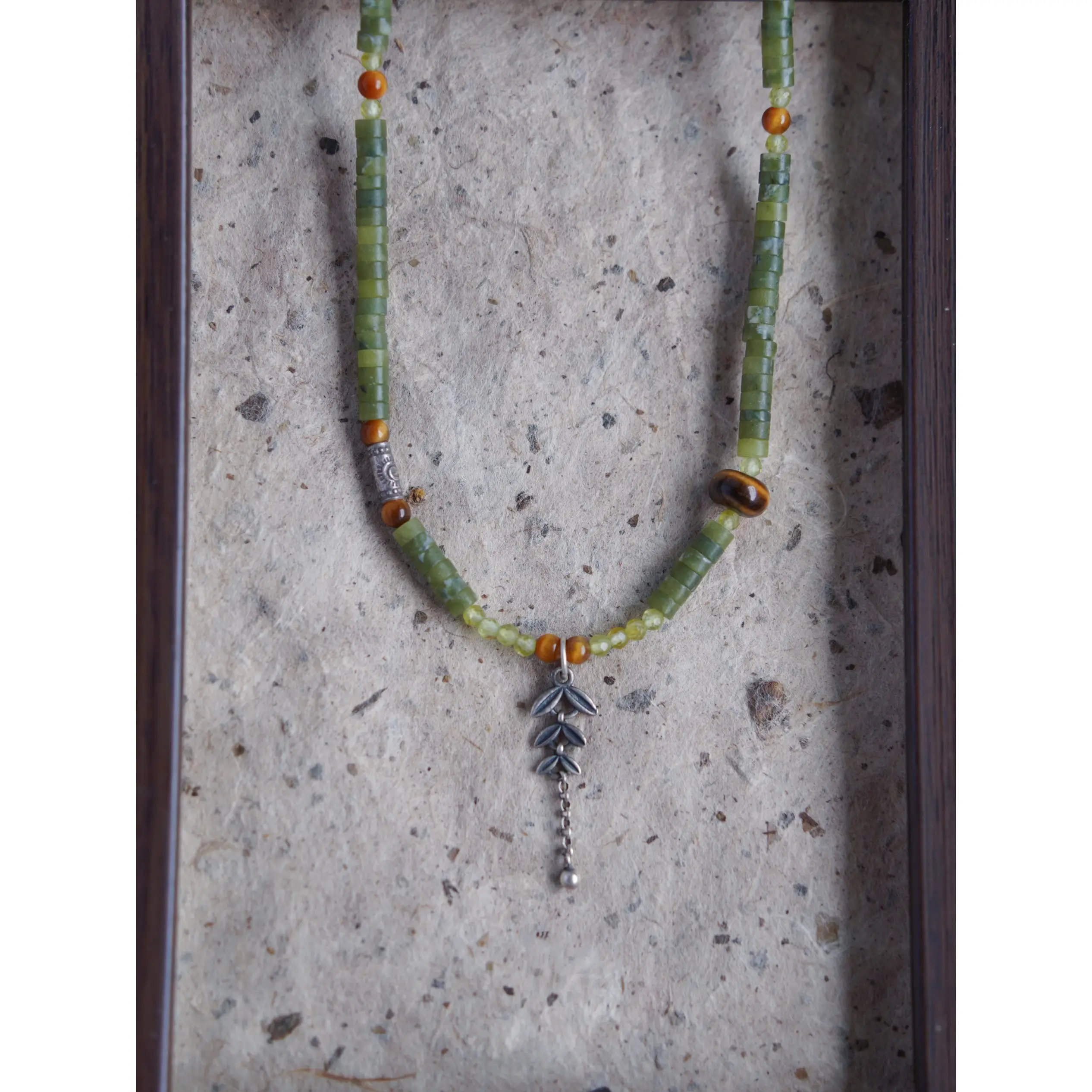 Handmade jade necklace paired with sterling silver accessories, perfect for a vintage-style daily wear.