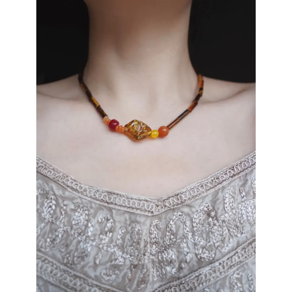  The model gracefully showcases our handmade jewelry to highlight its unique design and texture.