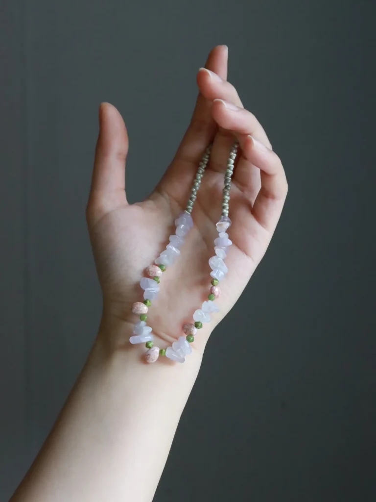 Model showcases a handmade vintage crystal necklace highlighting intricate craftsmanship and timeless beauty.