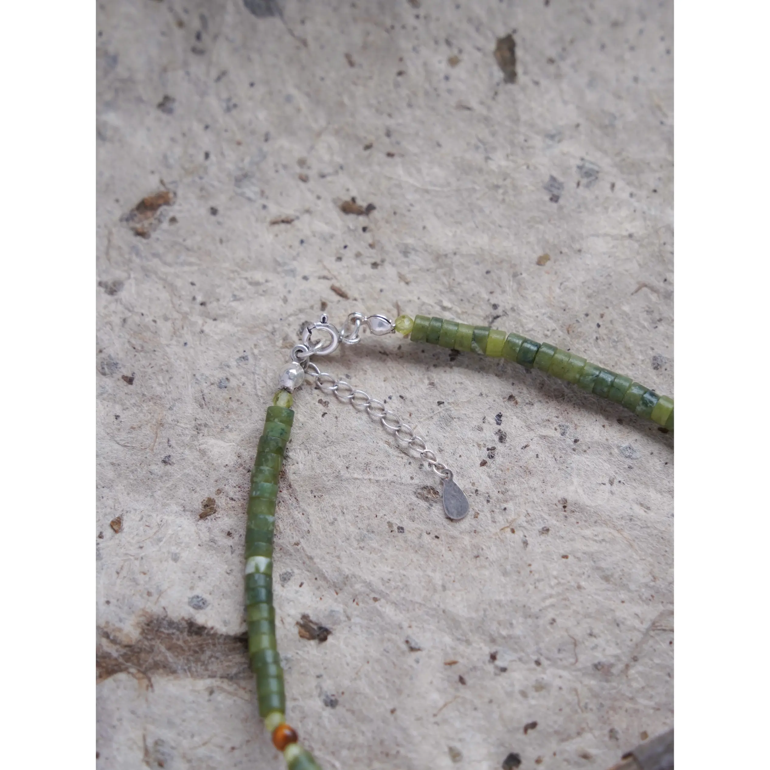 Handmade vintage necklace with sterling silver accessories, showcasing intricate detailing.