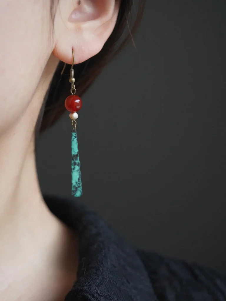 Delicate handmade earrings worn by model showcase refined craftsmanship while adding elegance to everyday fashion.