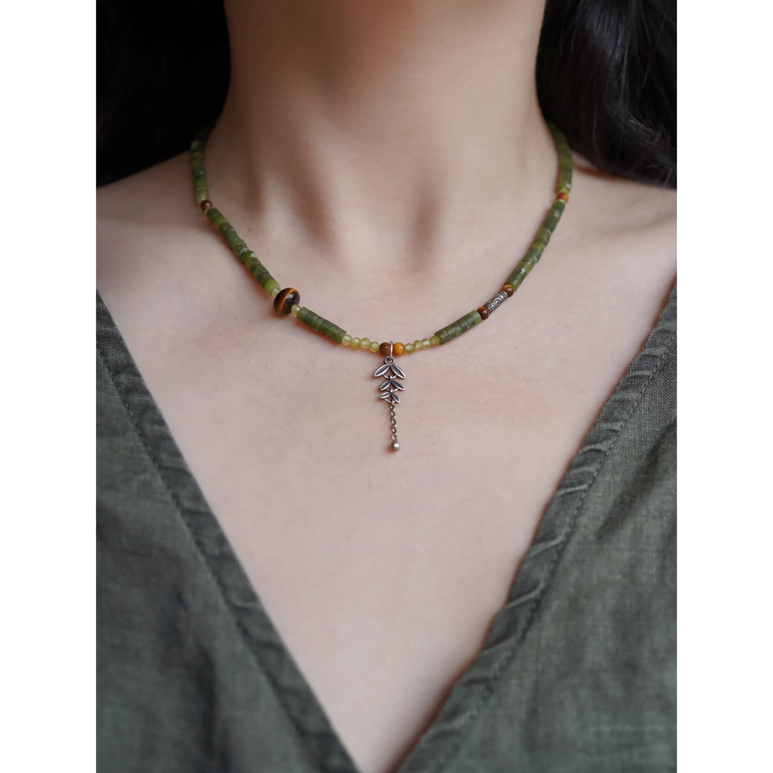 Model wearing a delicate handmade jade necklace, showcasing its elegance and craftsmanship.