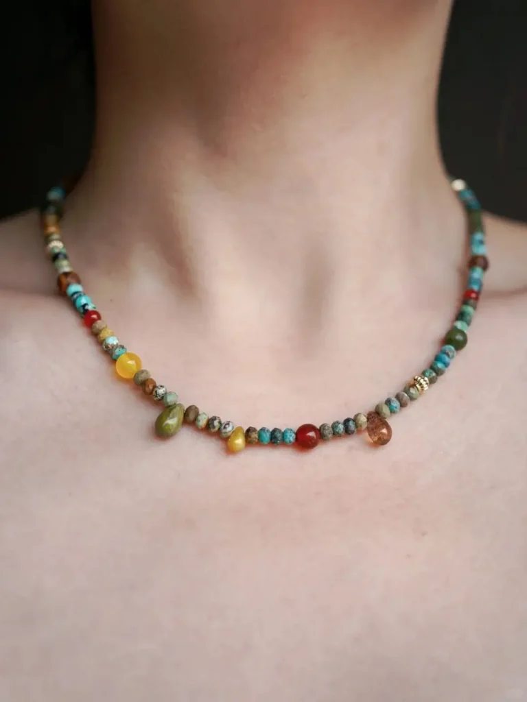 Wearing this handmade turquoise necklace, the model highlights its vibrant stones and bohemian charm under natural light.