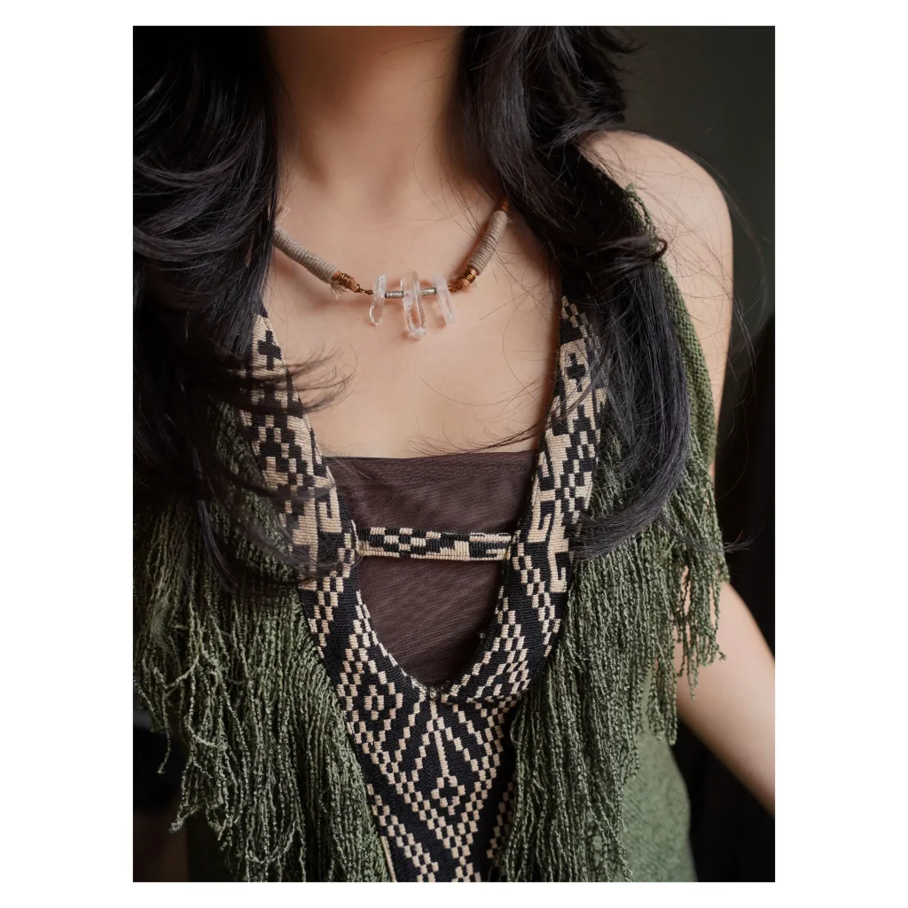 Model showcases vintage handmade white crystal necklace, expressing natural boho style.