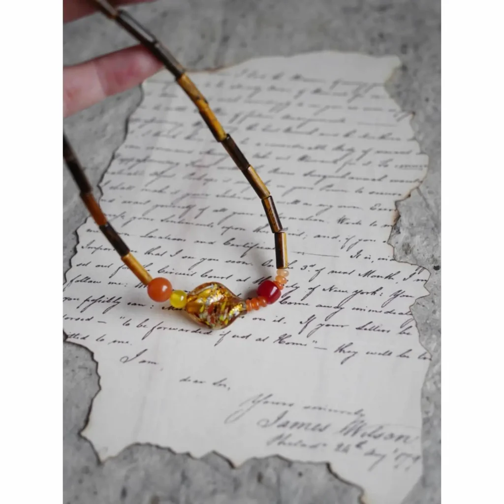 This handmade necklace showcases vintage flair with vibrant multicolor glass beads.
