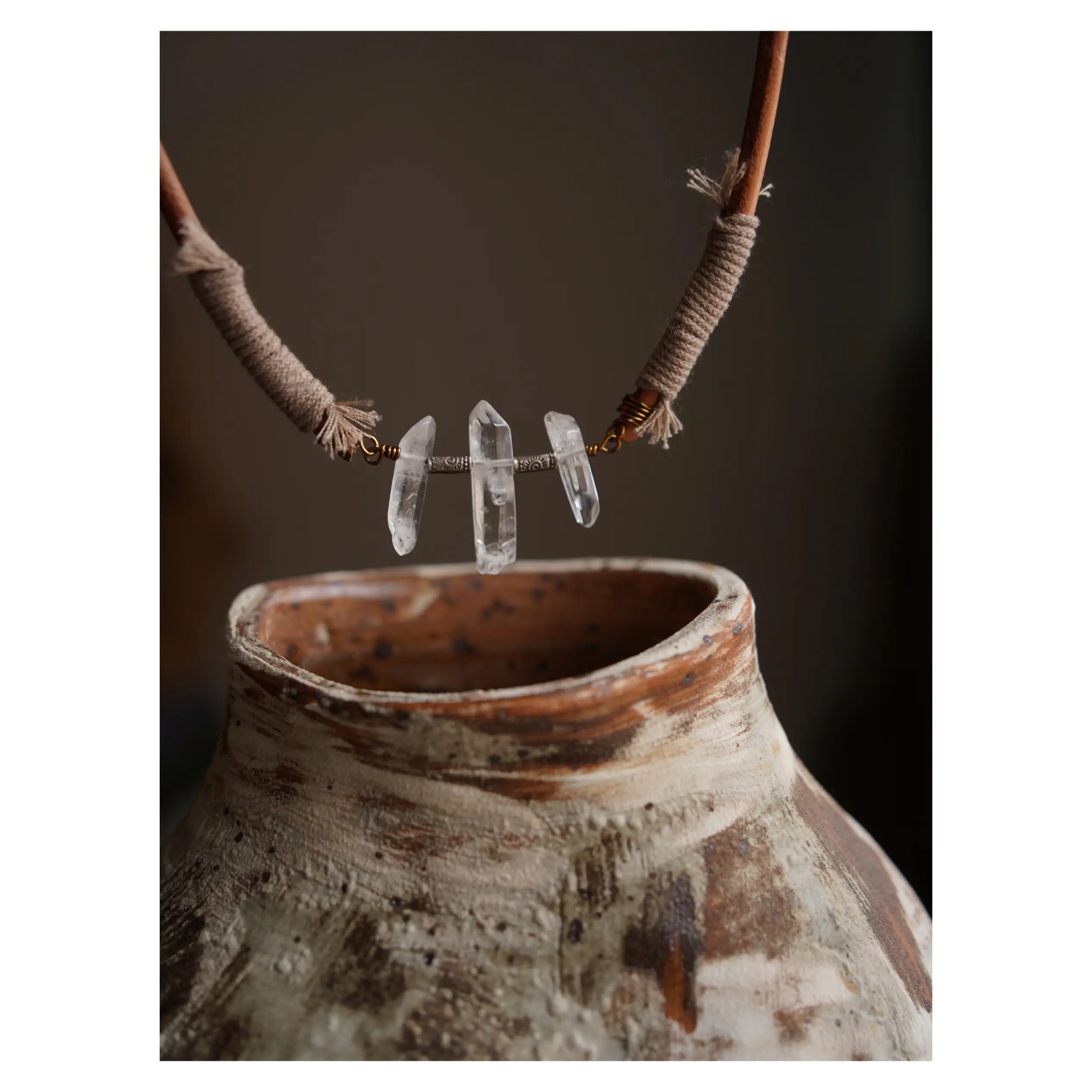 Natural cowhide leather necklace showcases white crystal in a handcrafted vintage-inspired design.