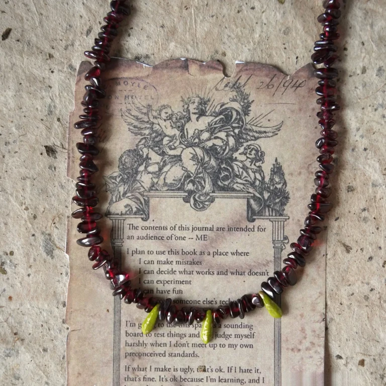 Vintage garnet beaded necklace features Czech glass accents and is handcrafted for versatile boho-style layering.