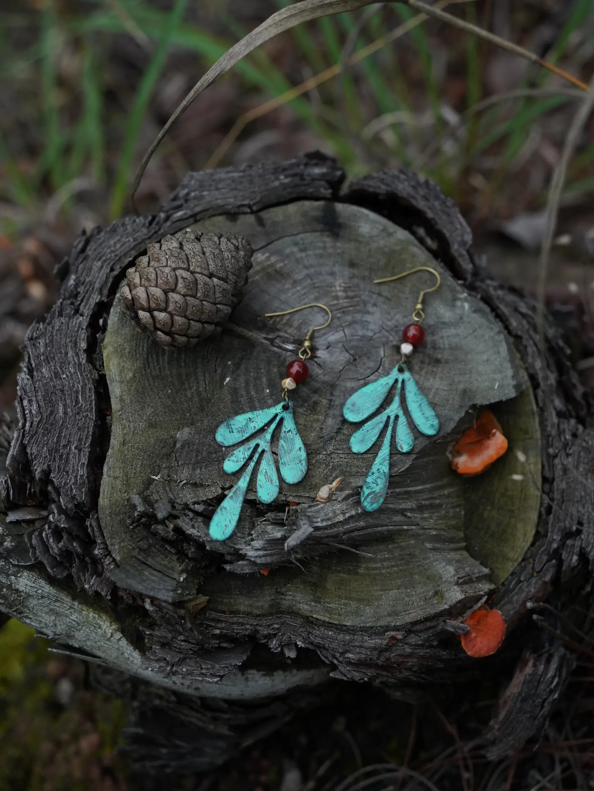 Handmade brass earrings with green patina finish and vintage-inspired texture