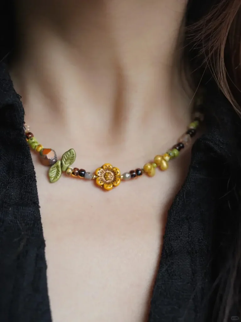 Model wears botanical beaded necklace to highlight the handcrafted vintage charm and natural aesthetic