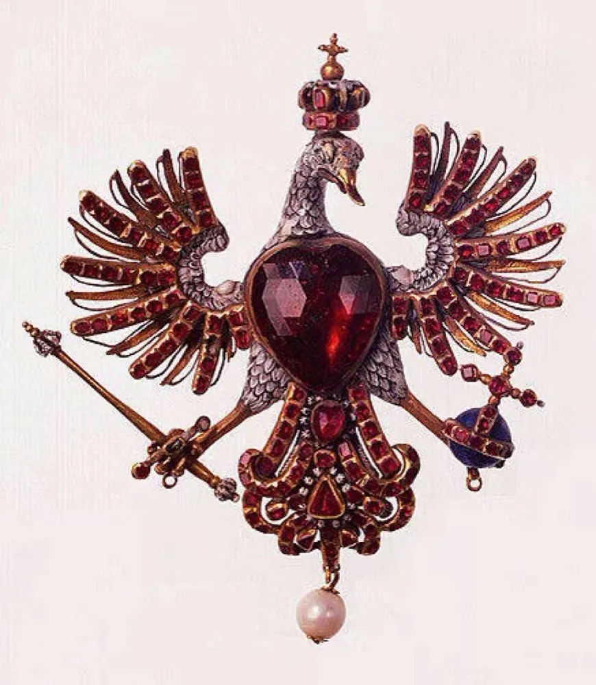Illustration of a garnet eagle brooch, featuring a large red garnet at the center, symbolizing the power and majesty of a sovereign ruler.
