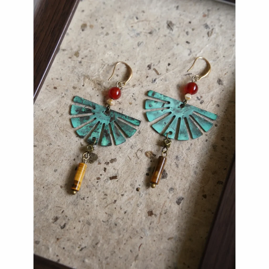 Bohemian fan-shaped earrings crafted from aged brass, handmade to add vintage charm to daily looks.