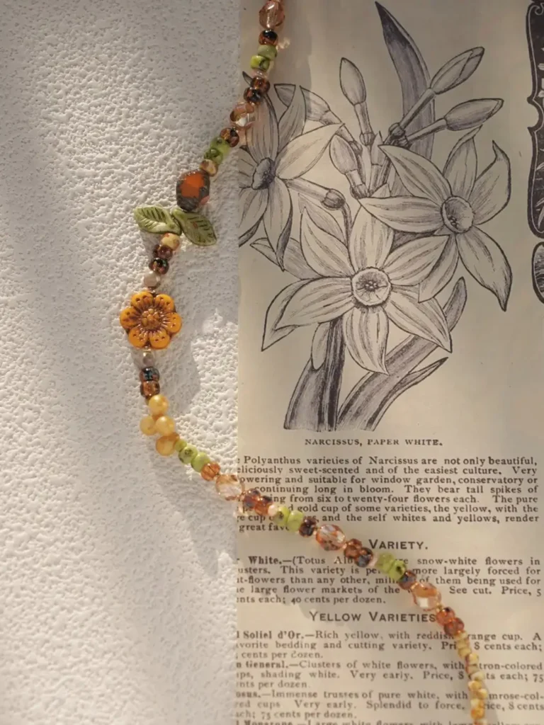 Handcrafted beaded necklace with vintage Czech glass beads, featuring a fresh botanical design.