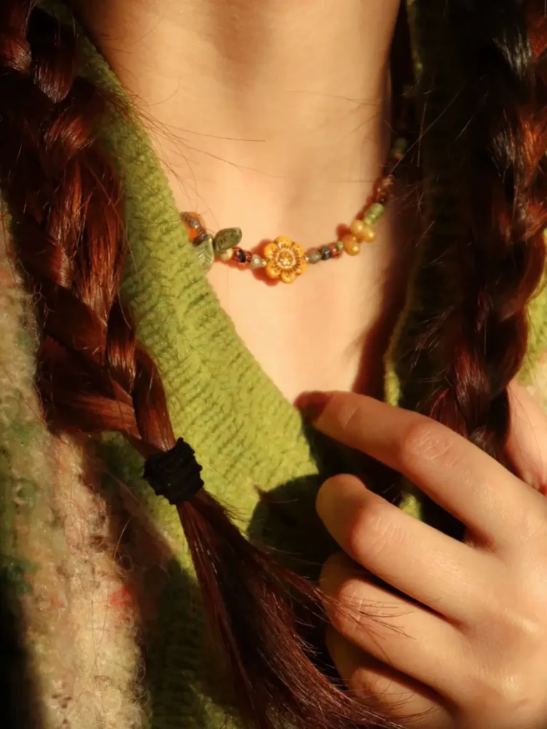 Model wears handmade vintage necklace that embodies botanical style and natural charm