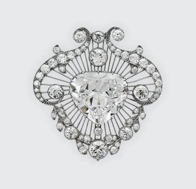 Illustration of a heart-shaped diamond brooch from Queen Mary's collection, showcasing the exquisite design and elegance of royal jewelry.