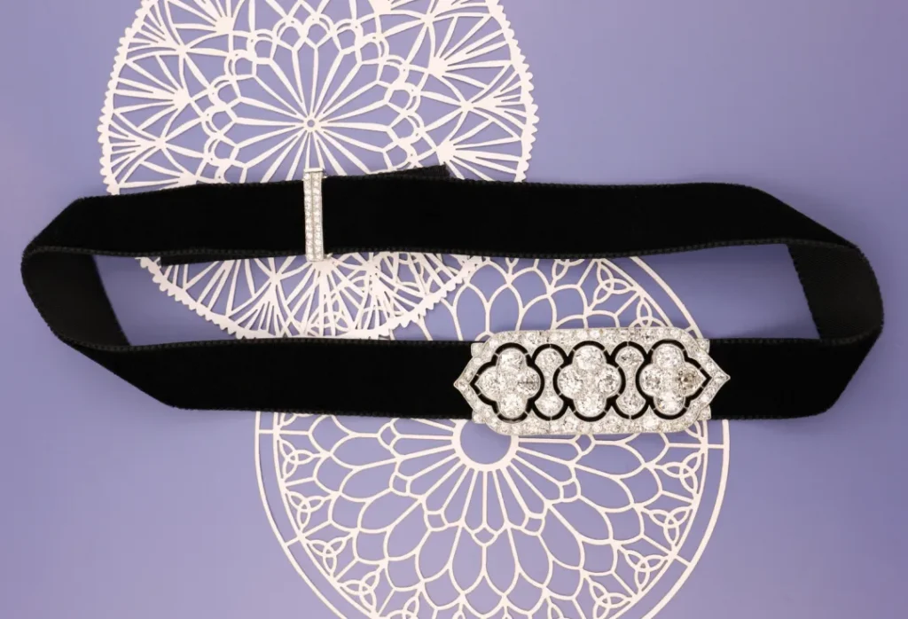 Delicate floral-style jewelry featuring soft lines, lace detailing, and diamonds, crafted with an airy and refined design characteristic of Edwardian-era elegance.