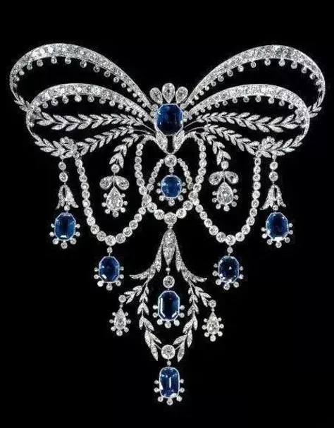 Luxurious platinum jewelry featuring diamonds and sapphires, showcasing intricate design and brilliance typical of early 20th-century elegance.