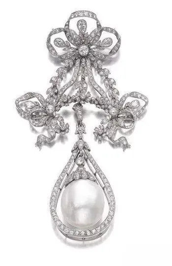 Elegant platinum and pearl jewelry, featuring delicate design and luxurious craftsmanship, characteristic of early 20th-century fashion.