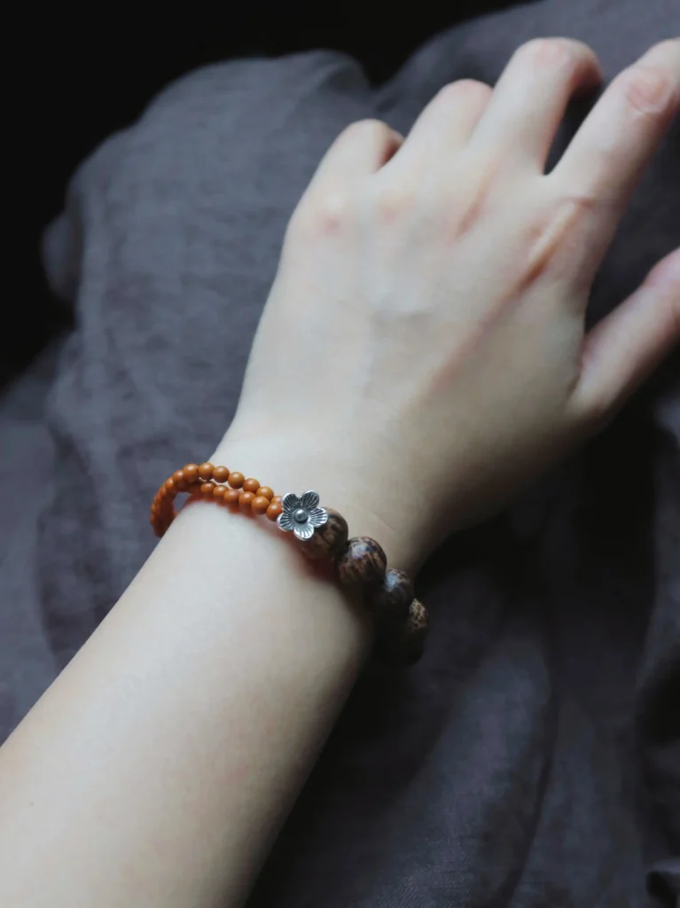 Model wears a handmade Thai silver flower bracelet that reflects artisanal charm and understated elegance