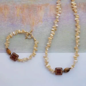 Natural stone jewelry combines Tonna shell beads with vintage-inspired design for everyday elegance.