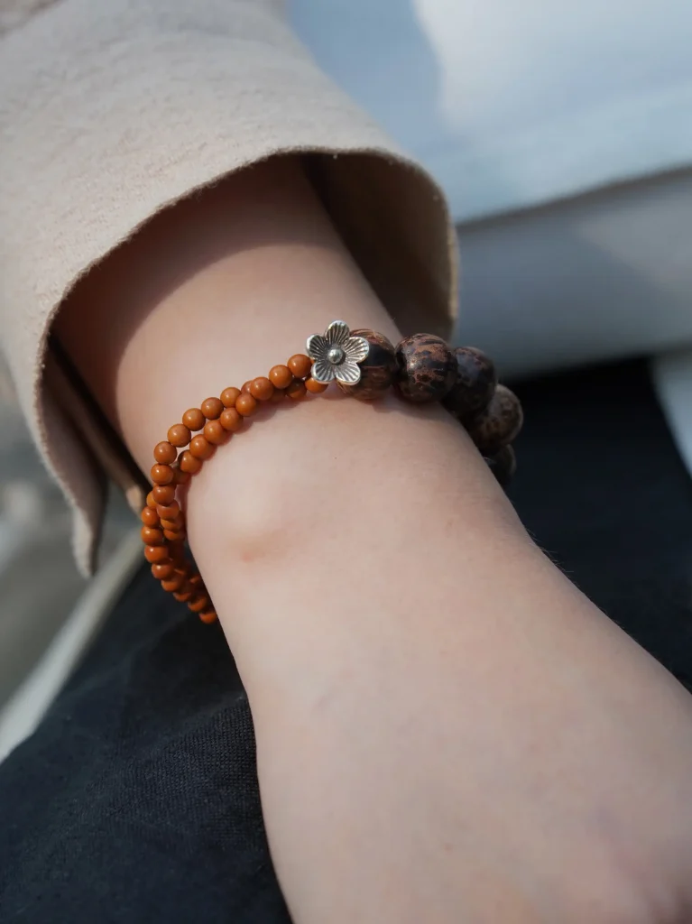Wearing a natural wood bead bracelet reveals organic texture and brings timeless simplicity to daily accessories