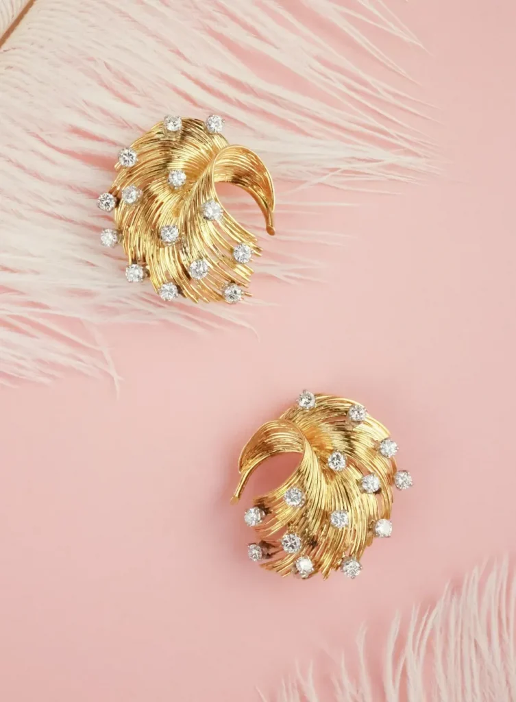  1950s-1960s Retro jewelry with scroll, fan, and rose designs, marking the return of gold after the dominance of white metals.