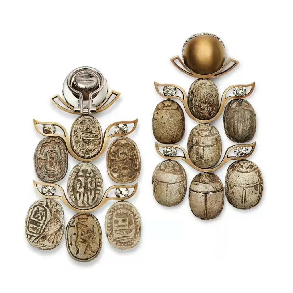  Illustration of a sacred scarab-themed vintage handmade  jewelry piece by Hemmerle, featuring an ancient Egyptian scarab seal as the centerpiece in an archaeological revival style.