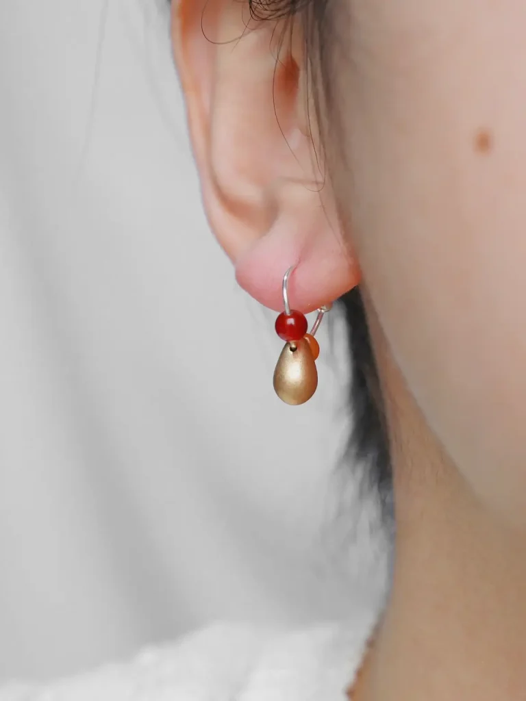 Handmade teardrop pendant earrings showcase a unique design and elegant charm..