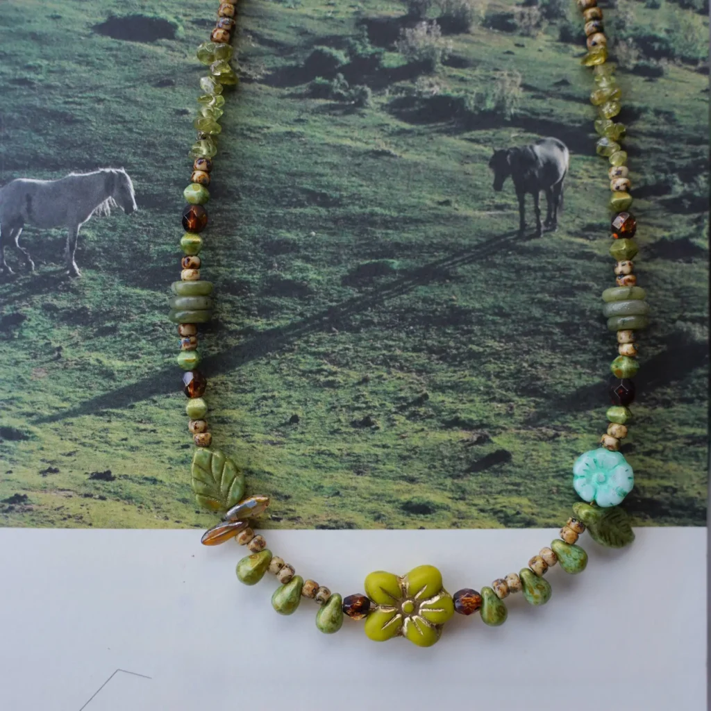 Original artisan necklace featuring a yellow flower centerpiece and vintage  beads, echoing the warmth of sunlit meadows.