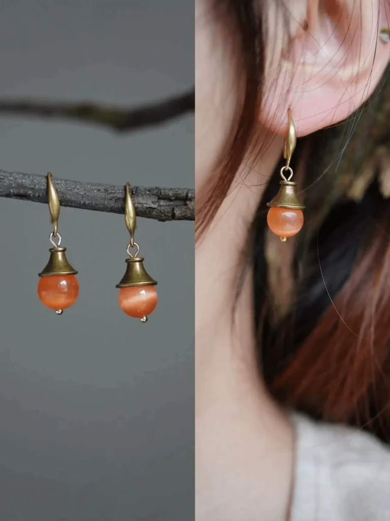 Handmade orange Cat’s Eye stone earrings, radiating vintage summer charm with natural warmth.
