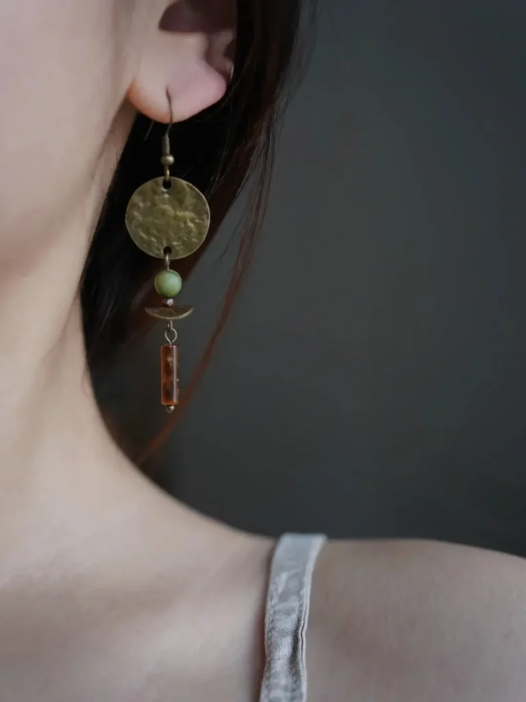 Model wearing handmade bohemian-style earrings.