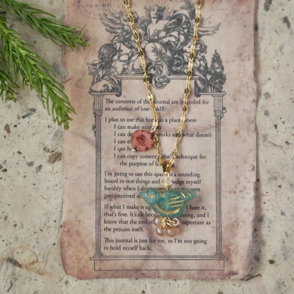 Blue thorn bird necklace