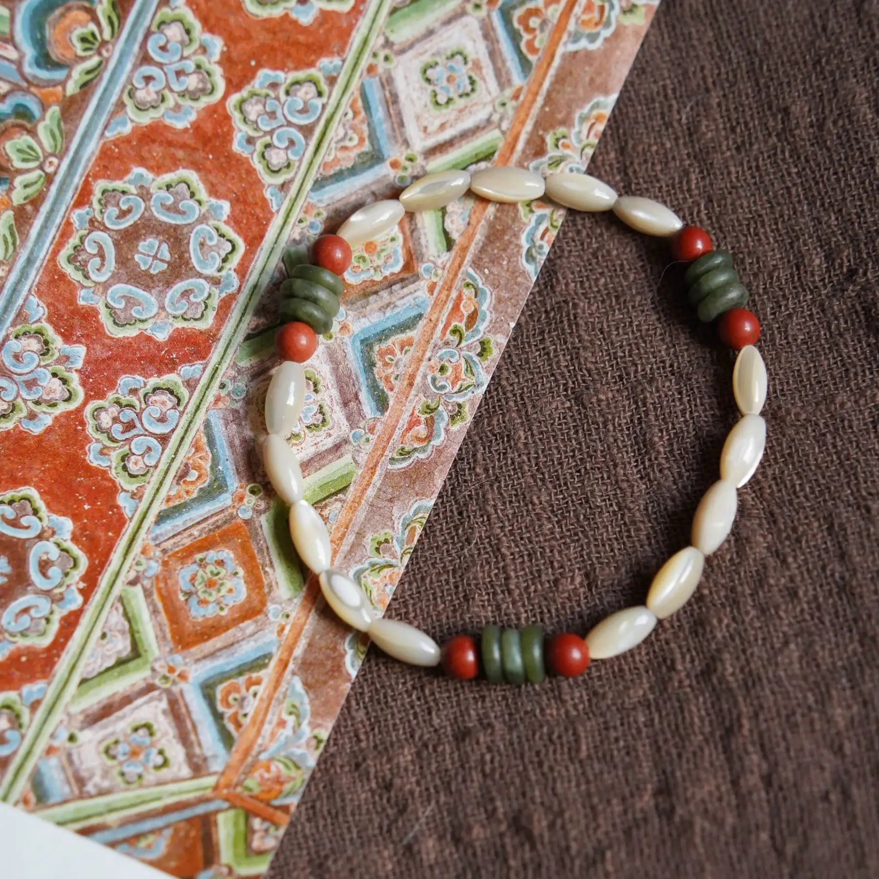 Handmade beaded bracelet from the Dunhuang collaboration, crafted with natural shells for everyday layered styling.