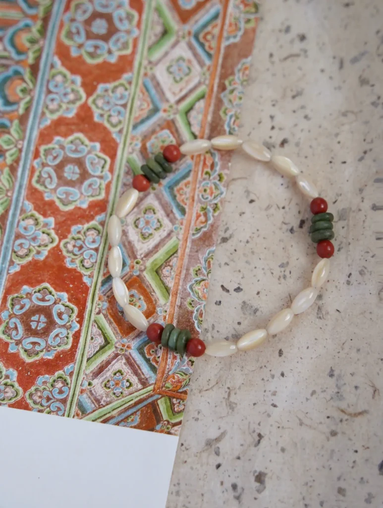 Handmade bracelet with shells, jade, and agate showcases Dunhuang-inspired design as a unique daily accessory for women.
