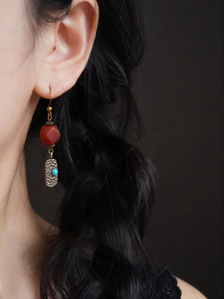 Handcrafted earrings worn on the ear, highlighting artisan design and elegant daily wear for women.
