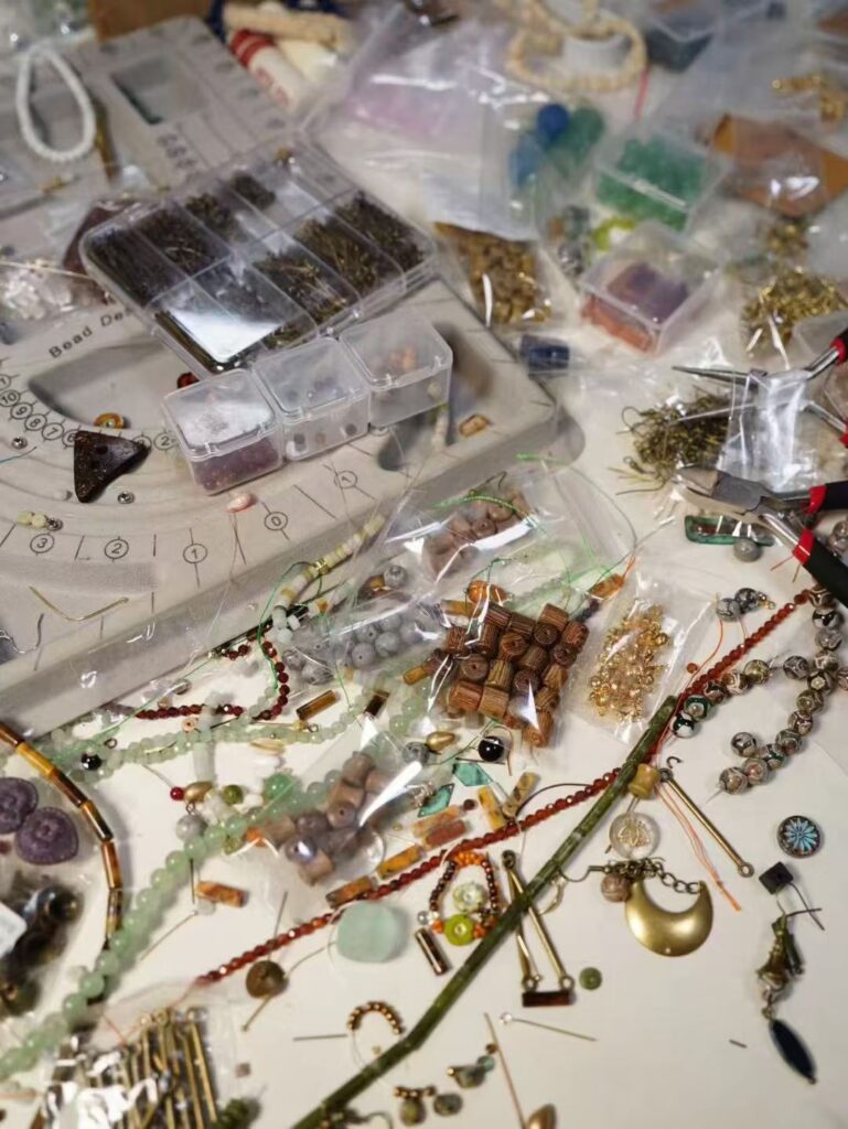 Jewea worktable with scattered beads for handmade vintage jewelry