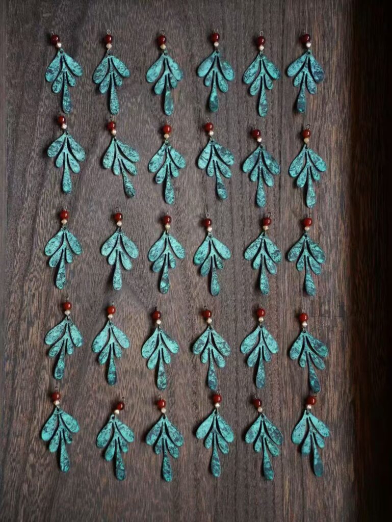 Artisan handmade earrings in assembly stage, showing craftsmanship details
