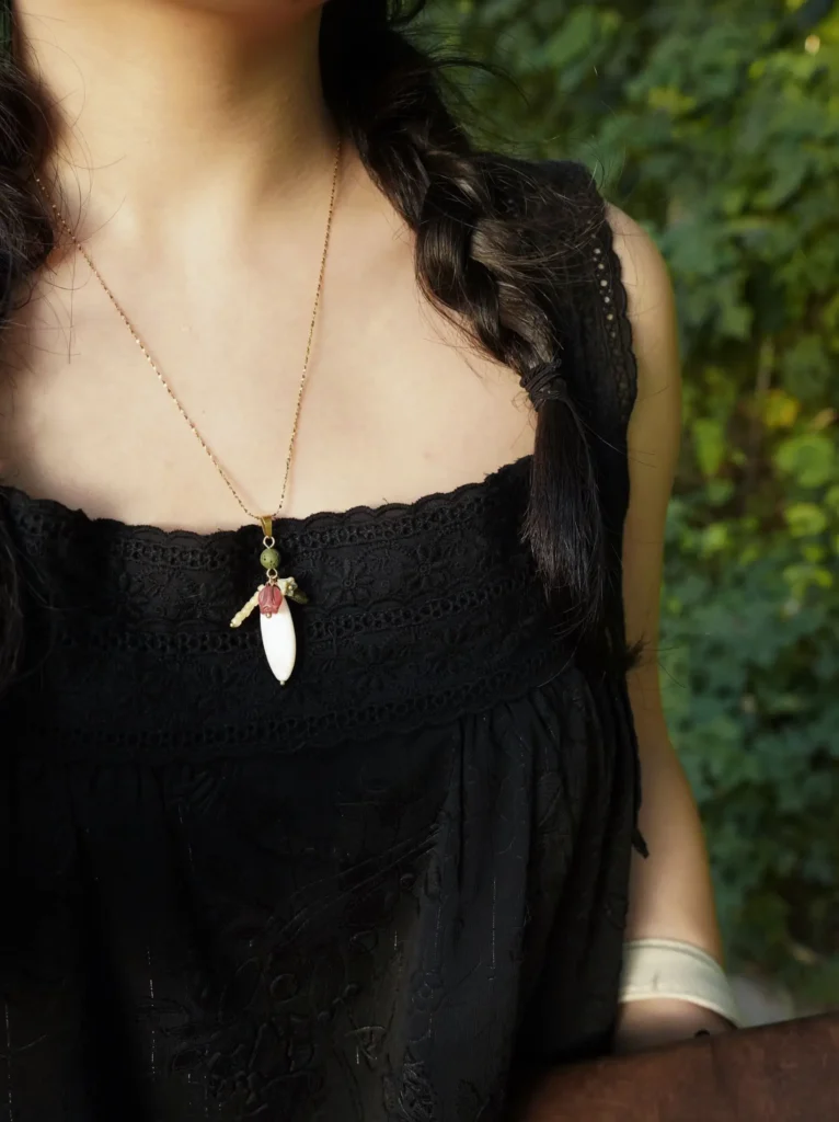 Model wears a handmade necklace, showcasing effortless daily styling and versatile layering for modern outfits.