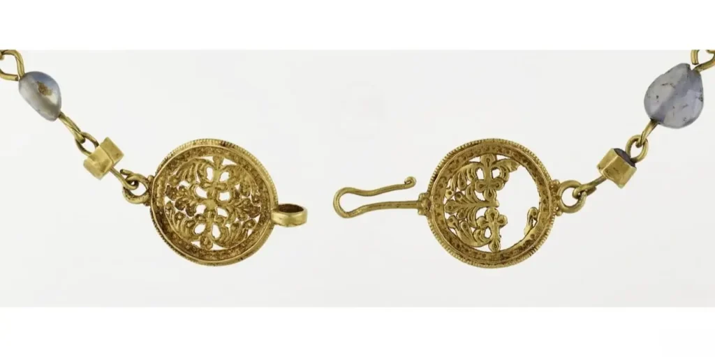 A detailed view of the Opus Interrasile clasp, showcasing refined Byzantine goldsmithing and intricate openwork design.