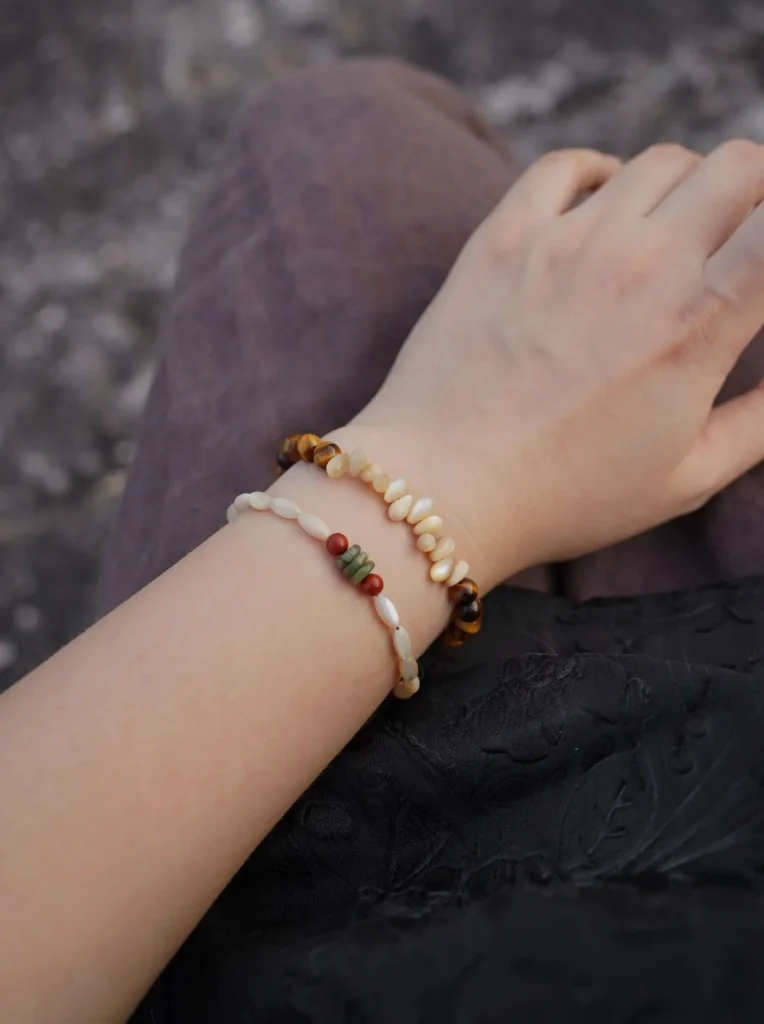 Stacked beaded jewelry showcases layered styling for daily wear, highlighting handmade craftsmanship and versatile design.