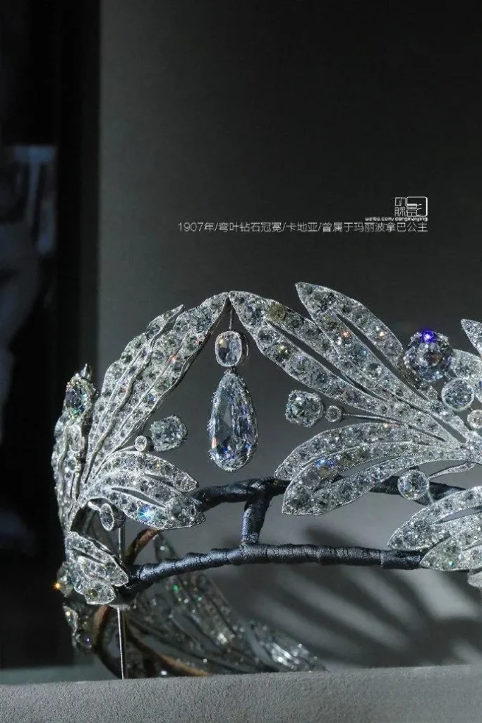 An illustration of a diamond tiara crafted in 1907. The crown is characterized by its curving leaf motif, inspired by laurel leaves, and is pavé-set with sparkling diamonds. It showcases the fluid lines of the Art Nouveau style combined with a classic aesthetic.