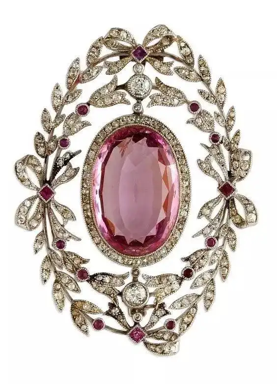 A vintage 1910 Edwardian-era pink topaz brooch featuring a 9-carat stone, highlighting Topaz colors and value with intricate metalwork.
