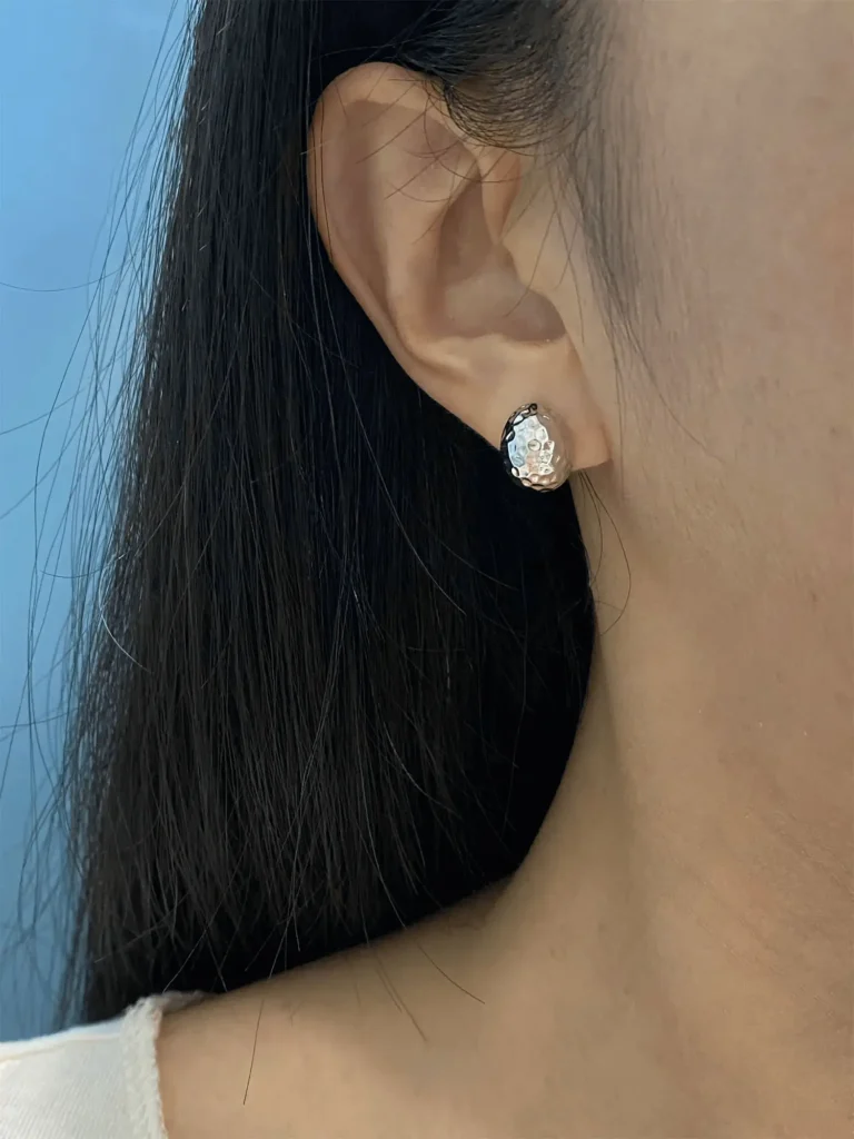 A woman wearing handmade earrings, perfect for subtle everyday elegance.