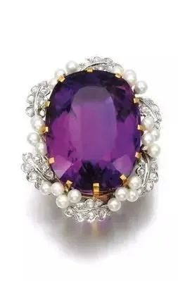  A pair of drop earrings with a single amethyst stone and a dangling pearl.