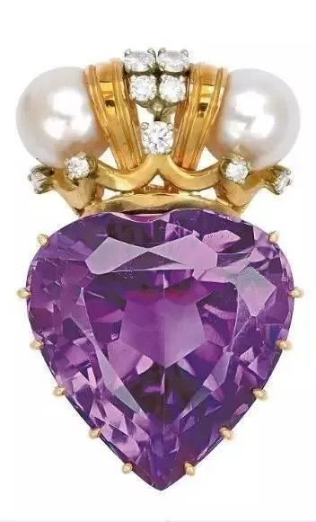 A gold pendant featuring a prominent amethyst stone, surrounded by shimmering pearls and diamonds.