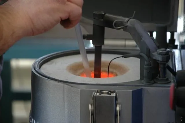 A plaster mold containing the wax tree being heated in an oven to remove the wax and prepare it for casting.