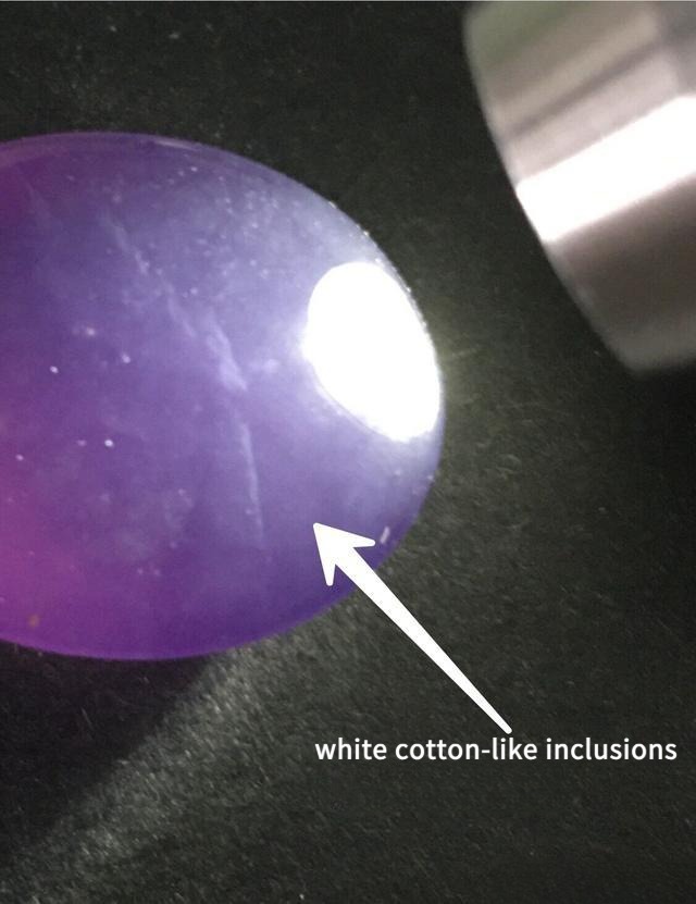 Microscopic view of Baoshan ice purple specimen showing white cotton-like inclusions and internal structure