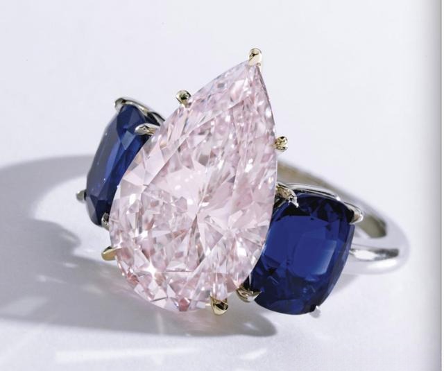 Blue diamond ring with pink diamond accents, highlighting the rarity of blue diamonds and enhancing the main stone's brilliance and romantic appeal.