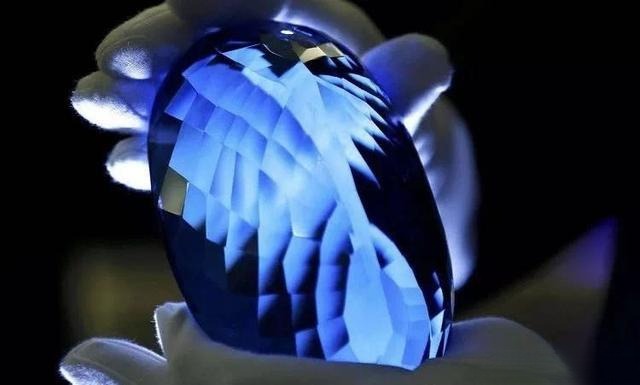 Blue topaz gemstone after irradiation and heat treatment, showing enhanced color and sparkle